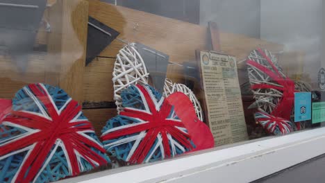 union jacks woven over frames in a window of a shop