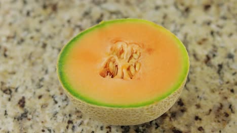 healthy half melon on the marbled surface in closeup