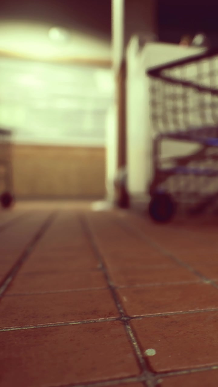 View of tiled floor near a shopping cart in a quiet indoor space