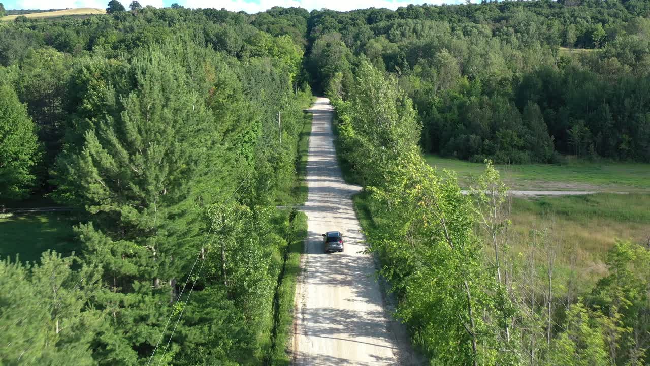 Top Down View of Cars Driving Along the Road Among the Forest