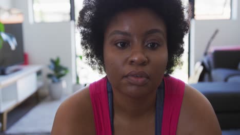 portrait of african american female plus size lying on exercise mat working out