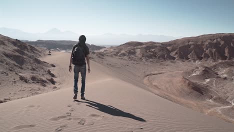 man slow motion walking in the desert sand dunes