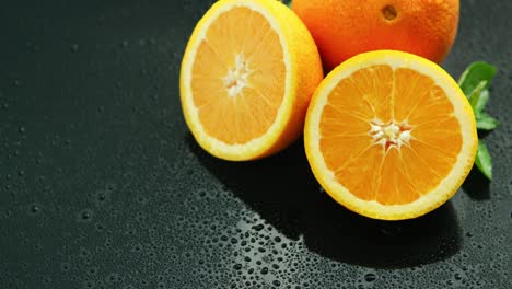 Orange-with-leaf-on-wet-table-