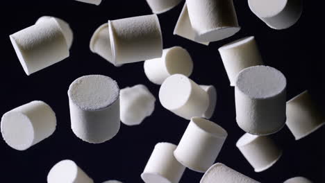 floating white marshmallows on a dark background