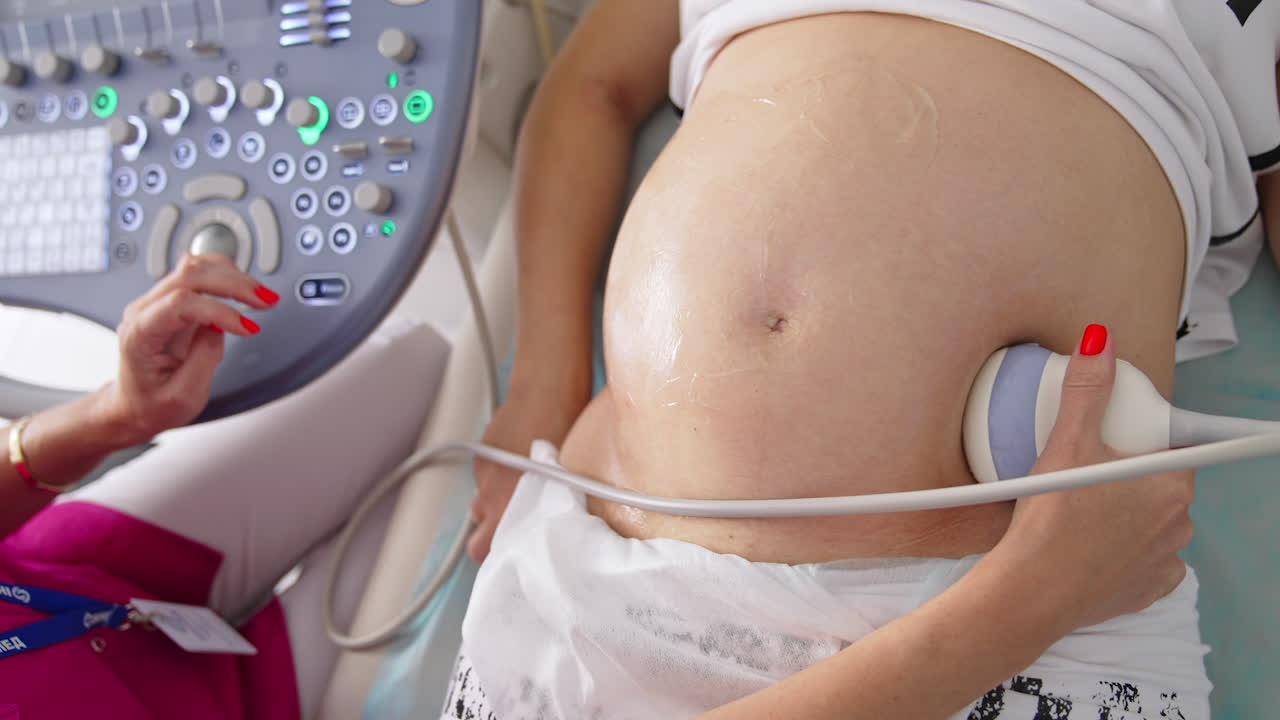 Pregnant Woman Having 4D Ultrasound Scan. Pregnancy and Healthcare concept. Prenatal Screening.