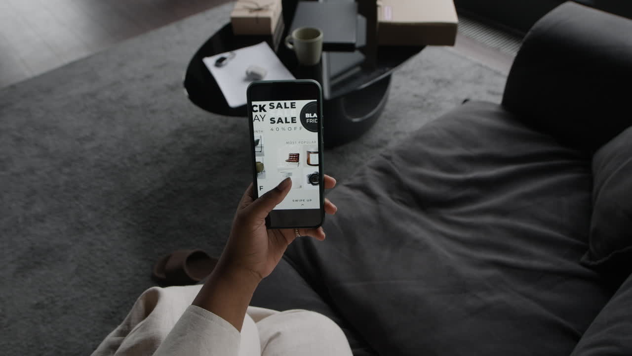A person using a smartphone on a couch