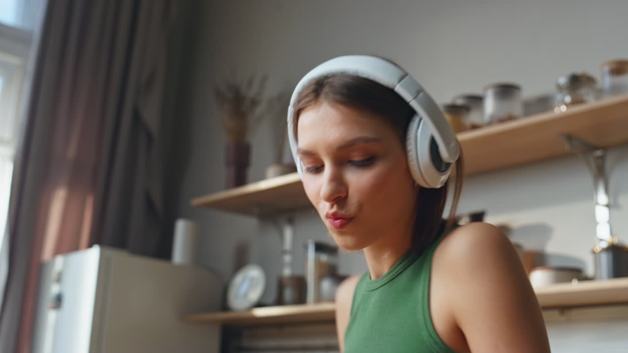 mujer escuchando musica en la cocina