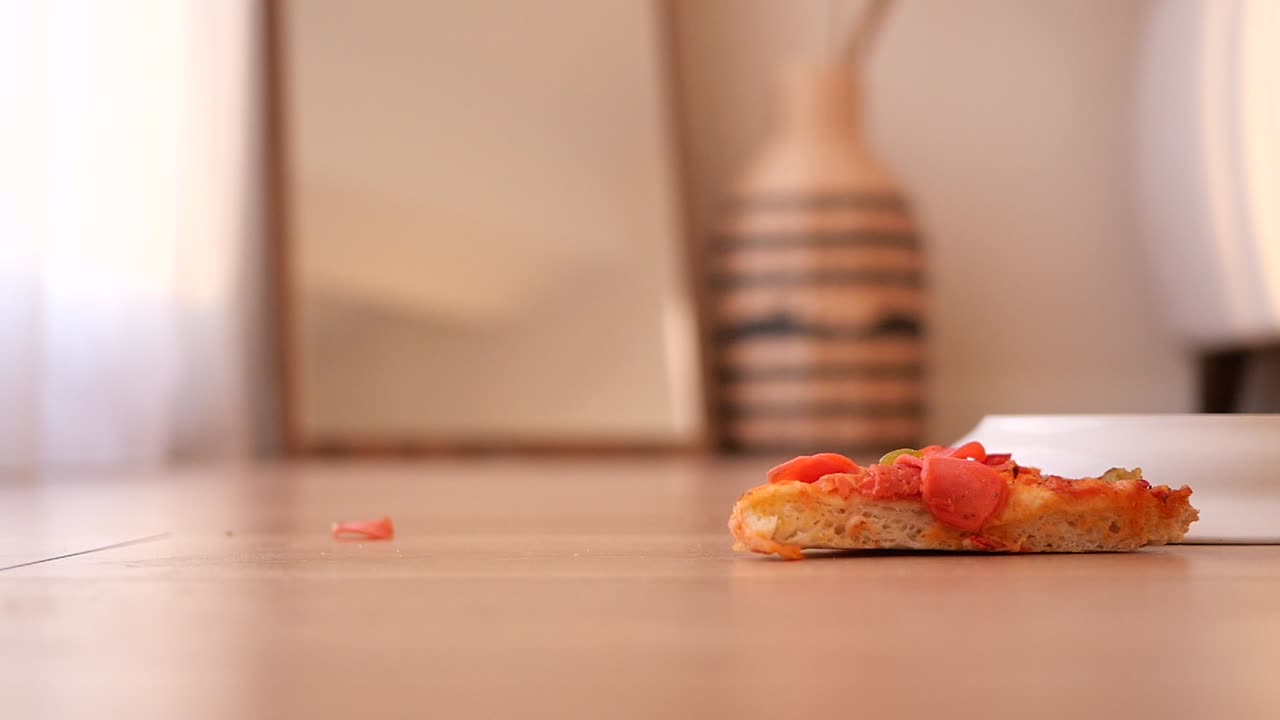 Table with pizza slice and other items