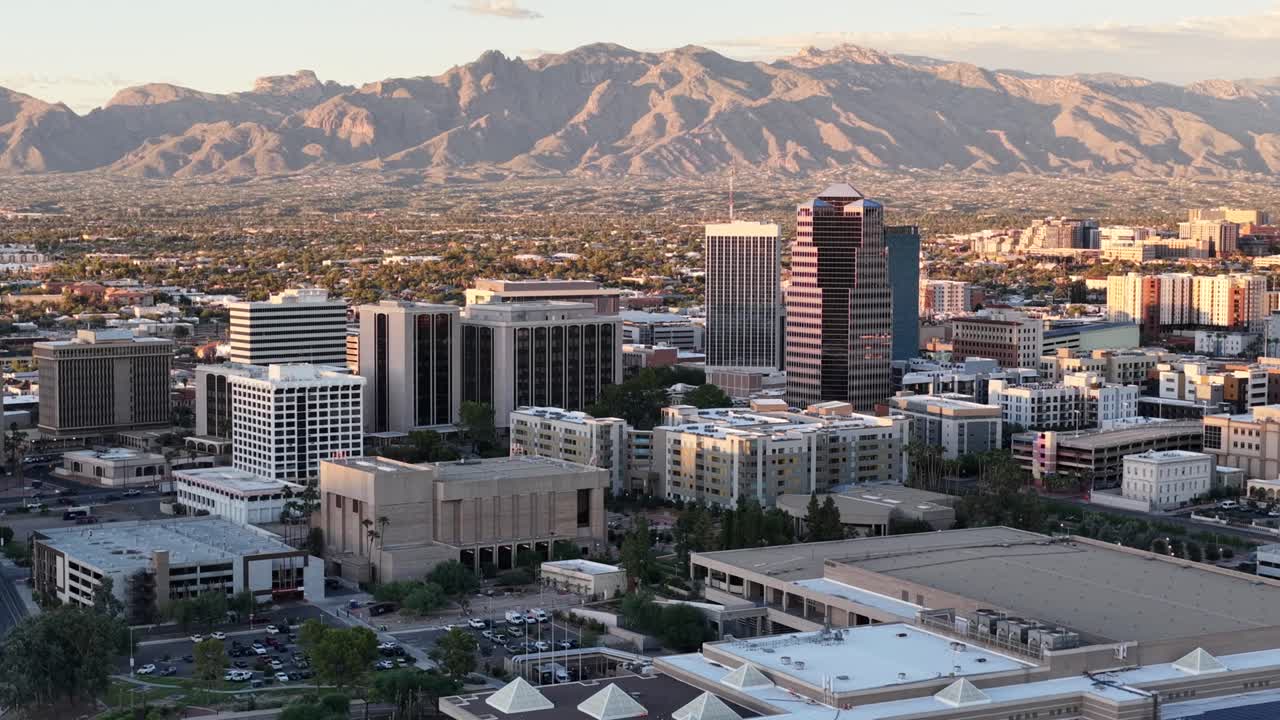 Wide descending circular push towards Downtown Tucson, Arizona Close to Sunset with Catalina Mountains in Background