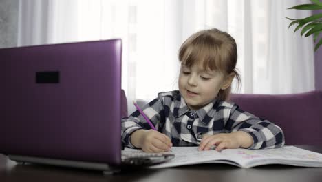 Girl-studying-online-homework-using-digital-laptop-computer.-Distance-education