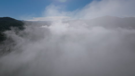 Morning-fog-blankets-serene-Lewis-River-Valley-in-the-Pacific-Northwest,-Washington-State,-drone-shot