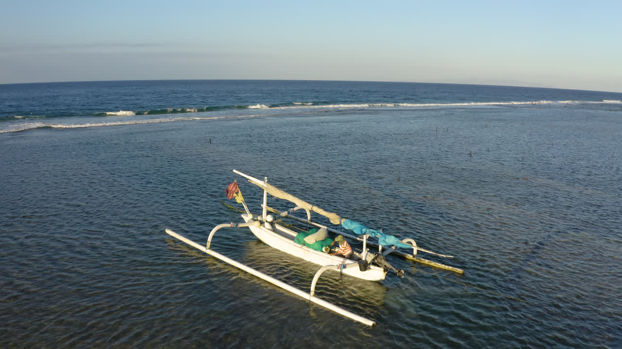 Forwarding drone in wind to capture Balinese Traditional Sailing Boat for Fisherman. Nusa Penida Beautiful Island with Traditional Wooden Boat in Middle of Indian Ocean. Filmed in 4k
