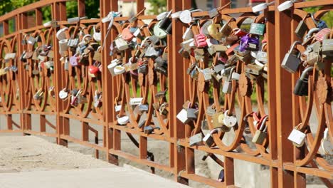 Set-of-wedding-padlocks-on-bridge-of-love-at-summer-park