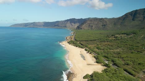 Aerial-view-of-Hawaiian-coastline-with-blue-skies-and-calm-waves