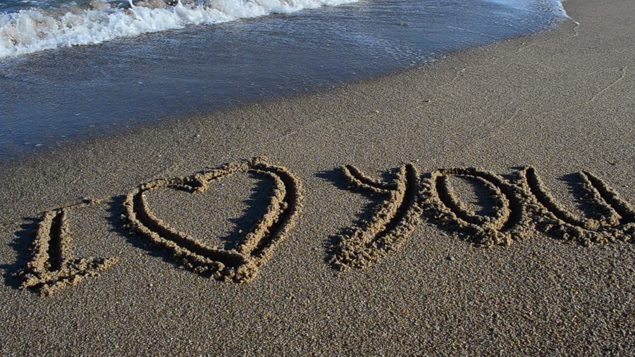 The phrase I love you on sand. Beach. Shooting on the beach