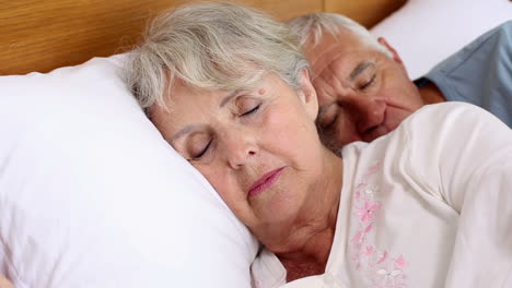 Senior-couple-sleeping-in-bed