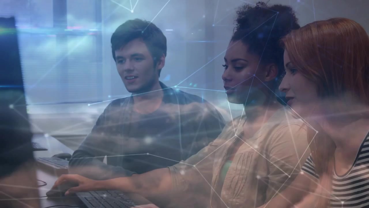 Software team typing at monitors for code review, displaying translucent network overlay