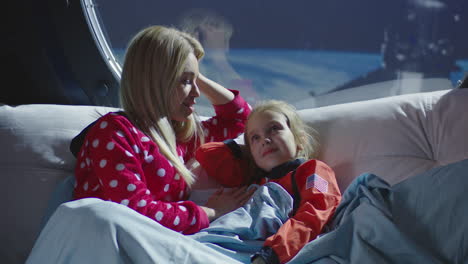 mother and daughter in space station