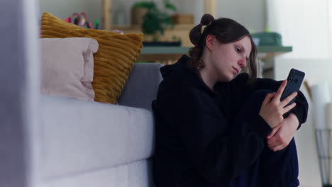 a teenage girl is browsing the internet and is sad and pensive