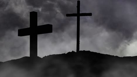 rocky-hill-and-two-crosses-silhouette,-dark-clouds-backgroun