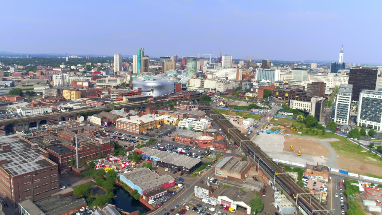 aerial drone shot of birmingham city centre flying backwards showing railways and birmingham landmarks in england uk