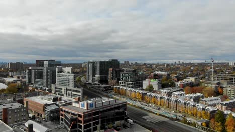 drone flying through toronto neighborhood in the fall going over train tracks