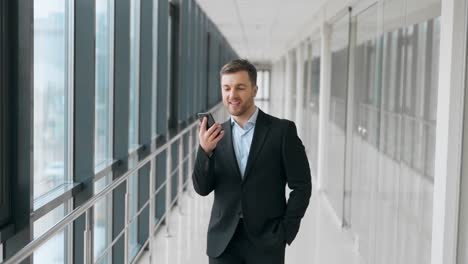 happy young man listening to music on smartphone and dancing