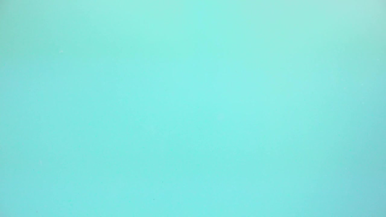 This is a video of blue gelatin poured into water.