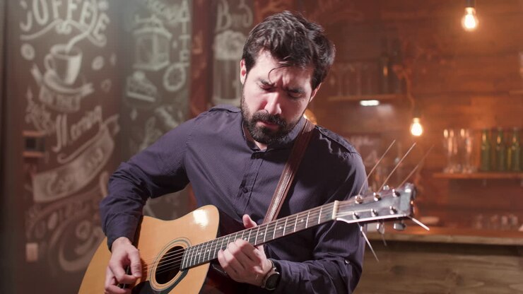 Man playing acoustic guitar in a bar