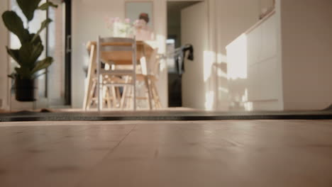 Young-male-Unrolling-yoga-mat-on-the-floor-at-home-in-sunlit-living-room