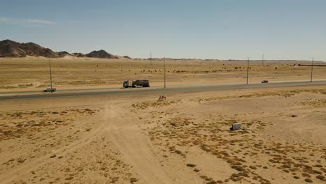 Water-track-drives-on-desert-highway-with-light-traffic