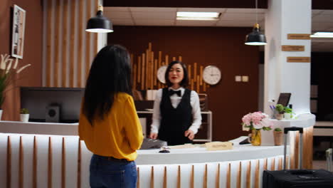 hotel guest calling upon front desk staff to give assistance