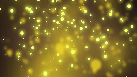 glowing yellow christmas light particles and bokeh lights moving on dark background