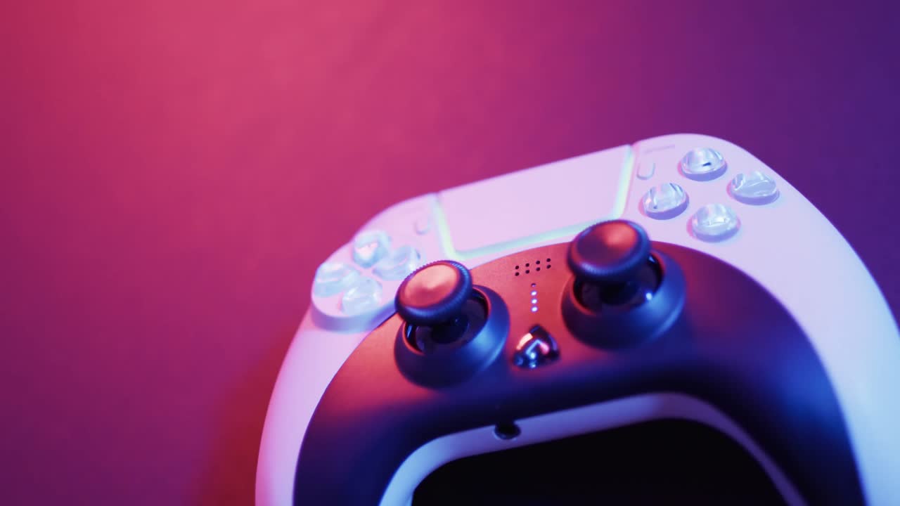 Video of close up of video game pad controller with copy space on neon background