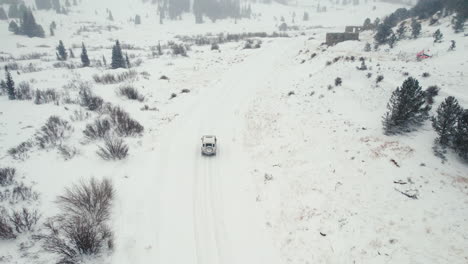 Land-Rover-Defender-D90-SUV-Off-Roading-Up-Snowy-Backcountry-Alpine-Forest-Road-In-Rocky-Mountains-Near-Nederland-Boulder-Colorado-USA-During-Moderate-Snowfall