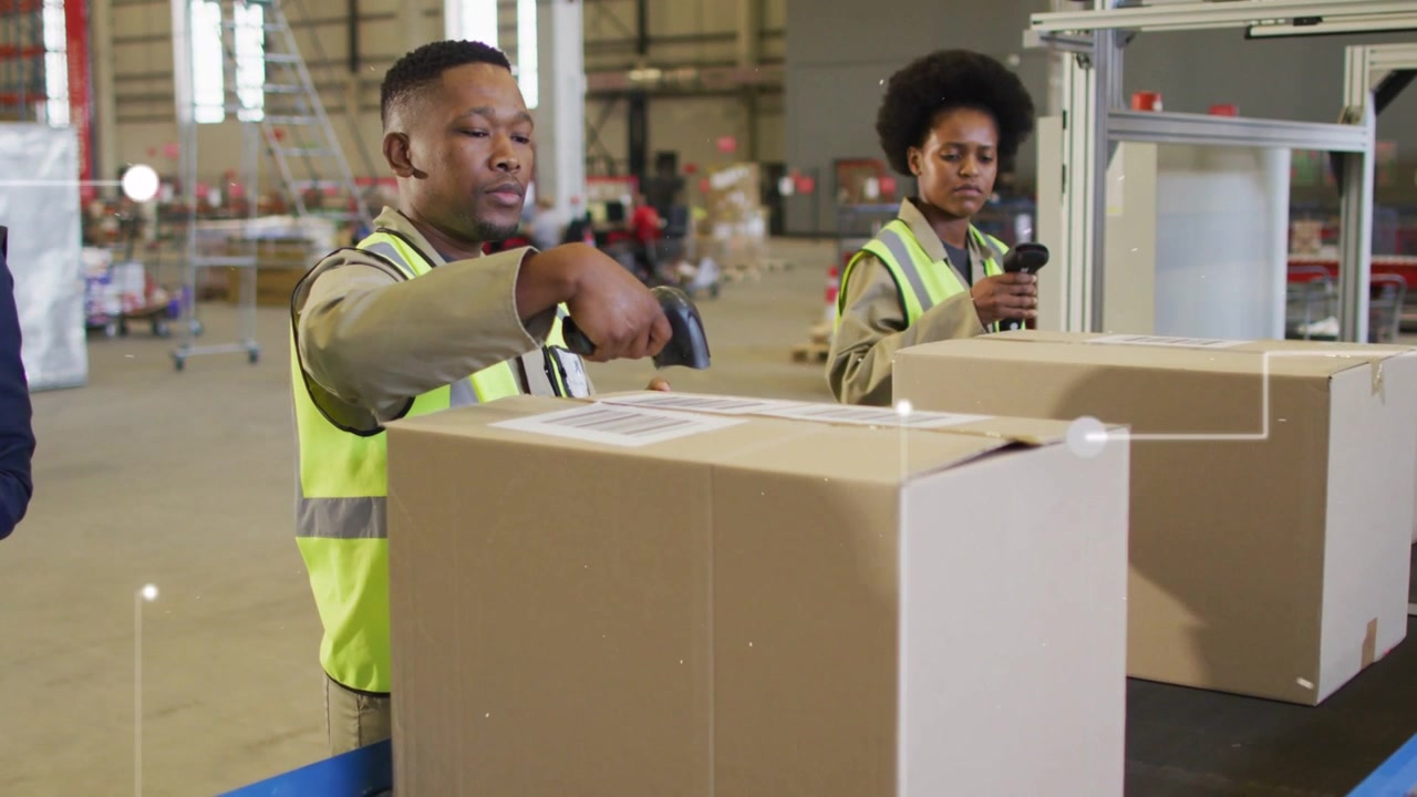 Warehouse packers bringing scanners to labels on line logging orders while lead monitoring tablet