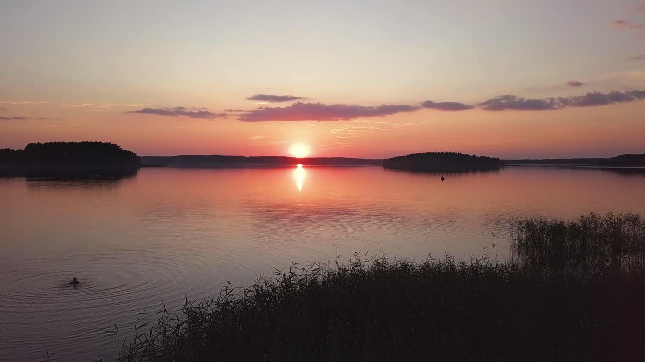 Sunset Over Lake Aerial. Revealing Shot