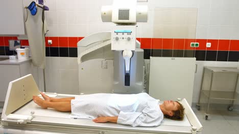 a female patient lying in x-ray room