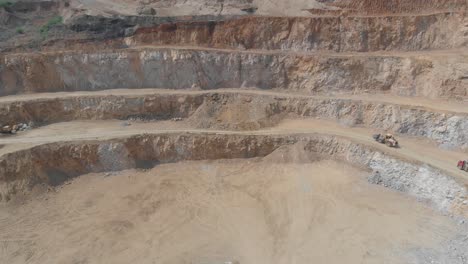 mining trucks moving up the mine. open-cut mine in poland. drone shoot.