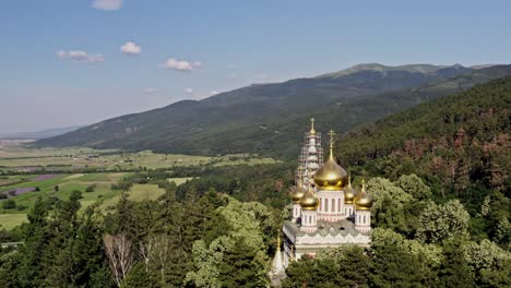 aerial view of shipka memorial church amid dense forest at the foot of balkan mountains bulgaria