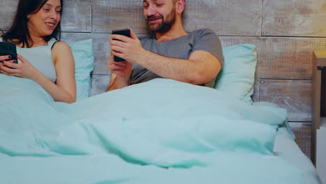 cheerful young couple using smartphone