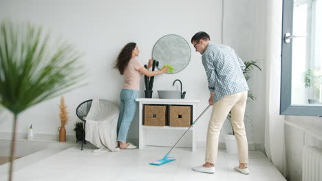 couple cleaning bathroom