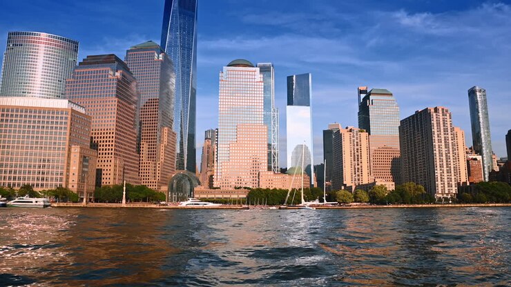 O sol ilumina as fachadas dos impressionantes edifícios no horizonte de Nova York. Passeio de barco pelo East River durante o dia