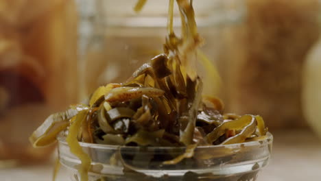 japanese wakame sea weed laminaria chuka fermented food. close-up on a detail of hiyashi wakame chuka or seaweed salad or seaweed with sesame seeds on a plate. top view. seafood background.