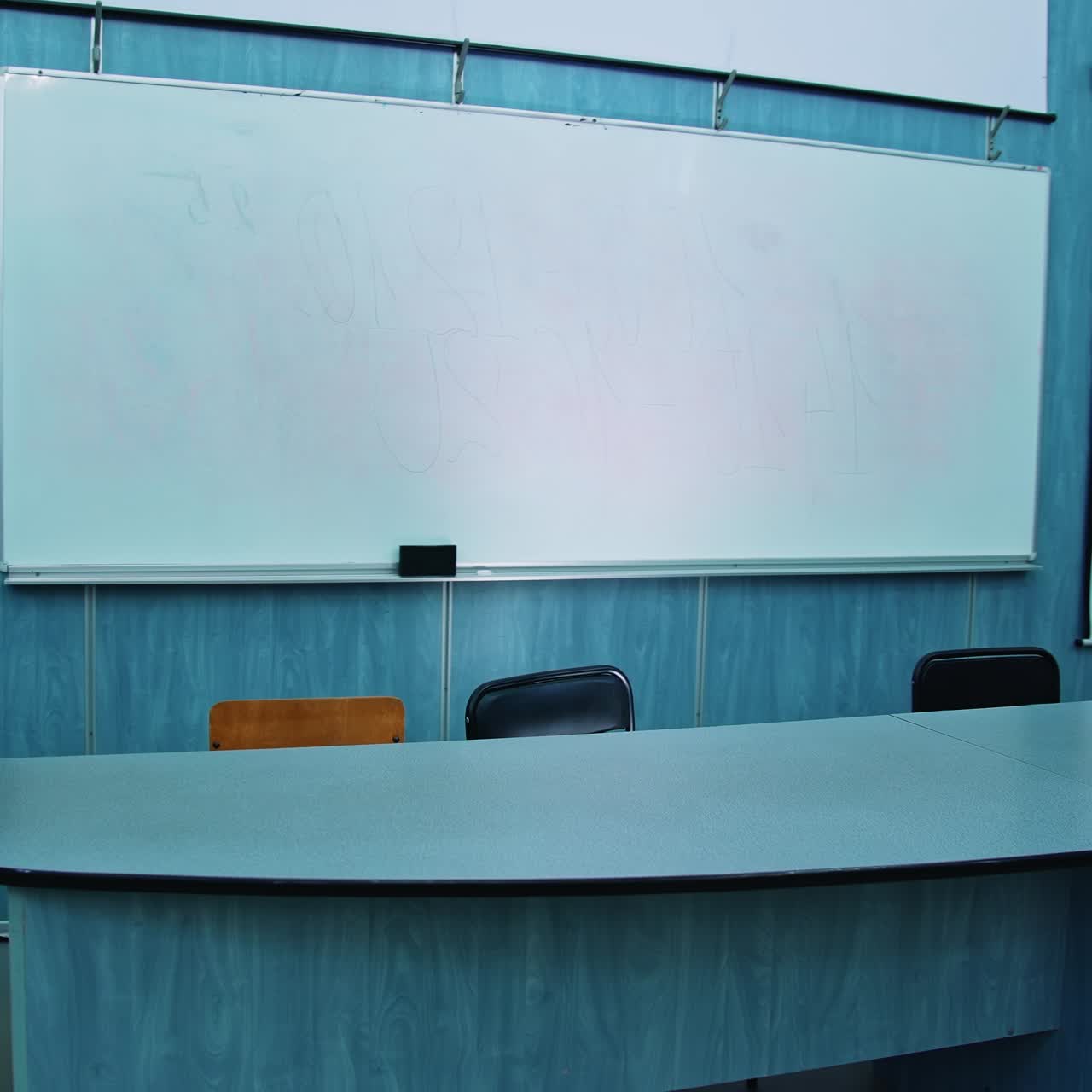 Presidium place with modern equipment. Auditorium with a blackboard, white board and teacher's table. Beautiful empty classroom in blue colors
