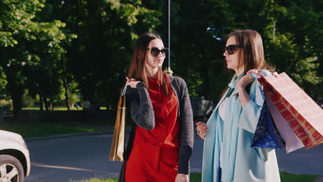 steadicam shot two girl friends with shopping bags talking outdoor