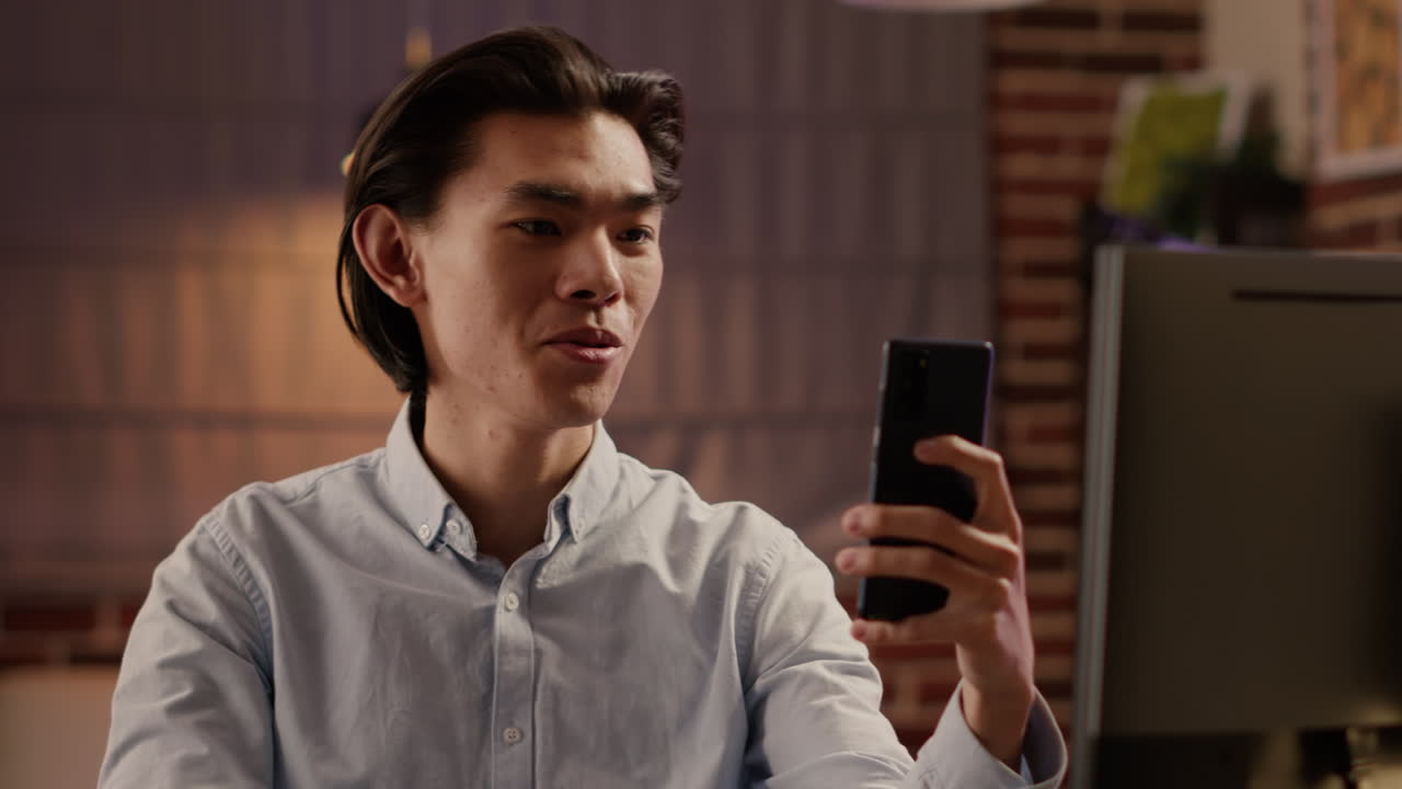 Man using smartphone near computer