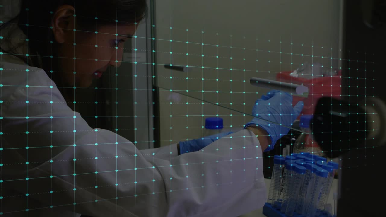 Indian woman at bench lab coat blue gloves reaching, placing tubes in blue rack, EKG pulsing