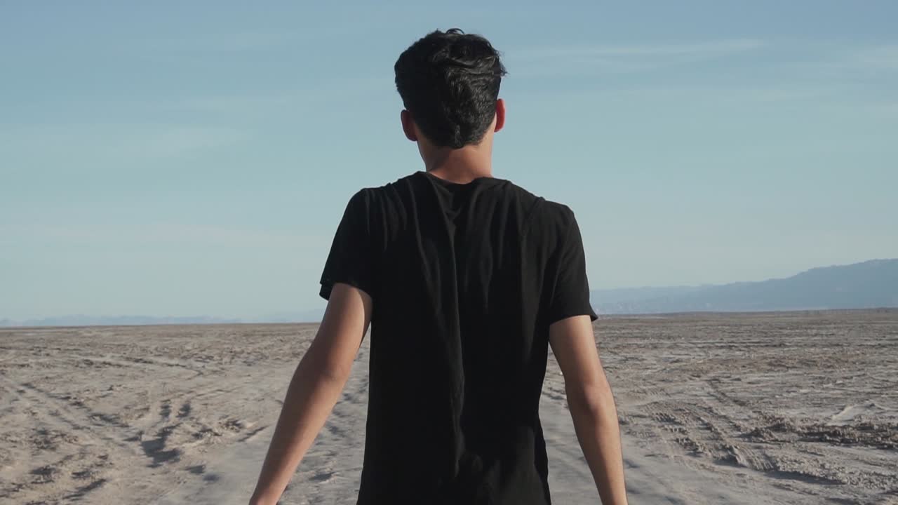 man walking through the desert quickly