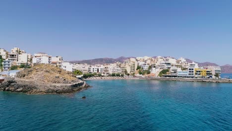 Drone-shot-over-the-marina,-seaside-boulevard,-beaches,-summer-in-Agios-Nikolaos-Crete-Greece